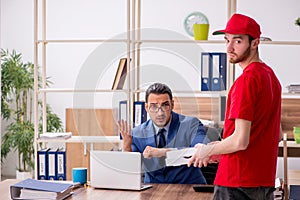 Young man delivering pizza to the office