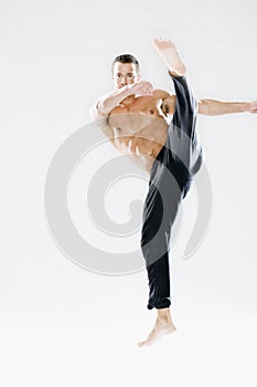 Young man demonstrating kick photo