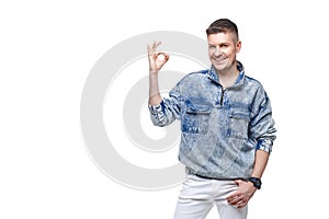 young man in denim jacket showing Ok gesture