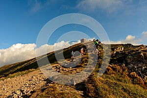 A young man descends from the top of the mountain Pip Ivan, observes the epic landscapes around the mountain, carries a large