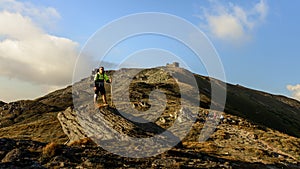 A young man descends from the top of the mountain Pip Ivan, observes the epic landscapes around the mountain, carries a large