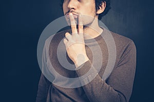 Young man displaying obscene gesture