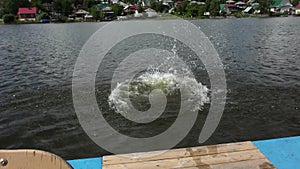 A young man dive from pedal boat in the water