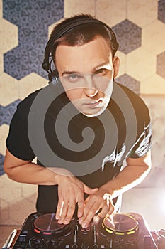 Young man DJ with mixer is working