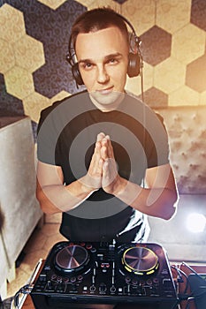 Young man DJ with mixer is working