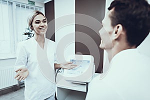 Young Man with Doctor in White Coat in Clinic.