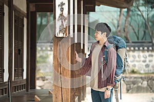 Young man doing a backpacking trip in a Korean traditional house.