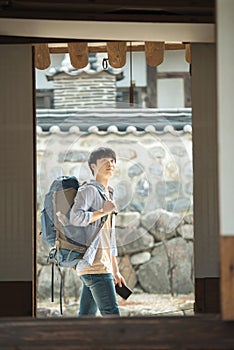 young man doing a backpacking trip in a Korean traditional house.