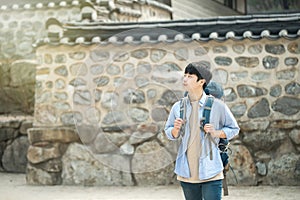 Young man doing a backpacking trip in a Korean traditional house.