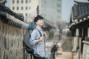 Young man doing a backpacking trip in a Korean traditional house.