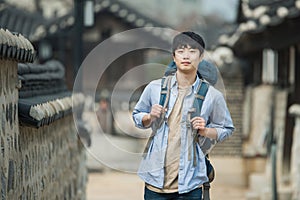 Young man doing a backpacking trip in a Korean traditional house.