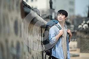 Young man doing a backpacking trip in a Korean traditional house.