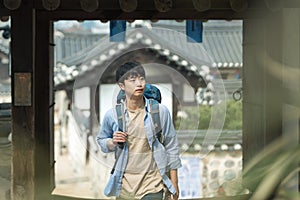 Young man doing a backpacking trip in a Korean traditional house.