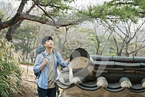 Young man doing a backpacking trip in a Korean traditional house.