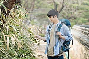 Young man doing a backpacking trip in a Korean traditional house.