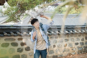 Young man doing a backpacking trip in a Korean traditional house.