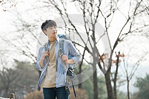 Young man doing a backpacking trip in a Korean traditional house.