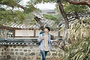 Young man doing a backpacking trip in a Korean traditional house.