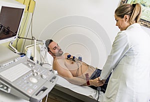 Young man doing EKG in hospital