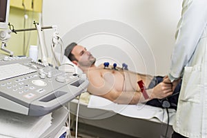 Young man doing EKG in hospital