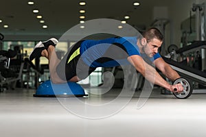 Young Man Doing Exercise On Bosu Balance Ball