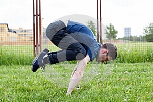 Young man doing an exercise in the city park