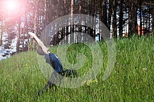 Young man doing exercise on the hill