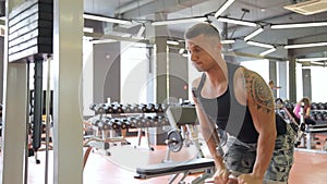 Young man doing exercises in a gym, workout