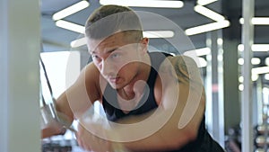 Young man doing exercises in a gym, workout