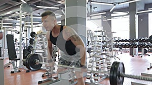 Young man doing exercises in a gym, workout