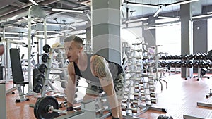 Young man doing exercises in a gym, workout