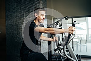 Young man doing fitness exercises on stepper at home gym.Making an effort and training for fit body shape,weight loss.Excess body