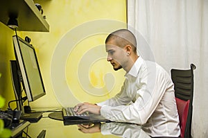 Young Man with Doing Homework at Computer Desk