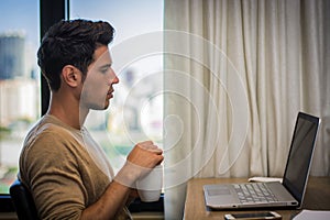 Young Man with Doing Homework at Computer Desk