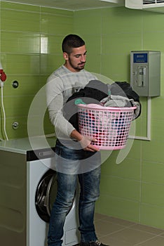 Young Man Doing Housework Laundry