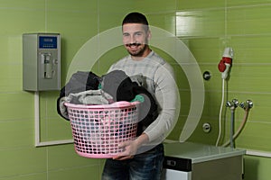 Young Man Doing Housework Laundry