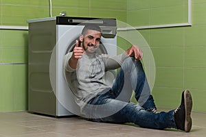 Young Man Doing Housework Laundry Thumbs Up Sign