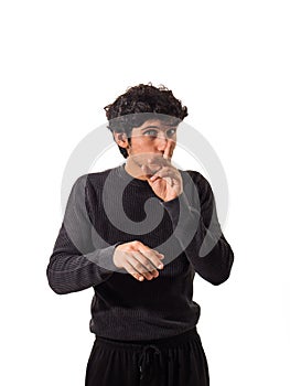 Young man doing hush sign with finger over his mouth
