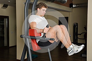 Young man doing lats pull-down workout