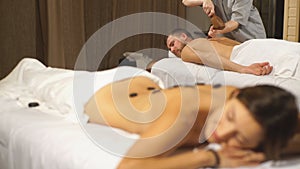 Young man doing a massage using a special hammer