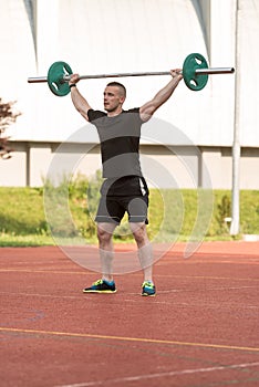 Young Man Doing A Overhead Squat Exercise Outdoor