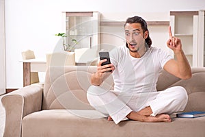 Young man doing physical exercises at home