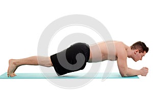 Young man doing planking exercise photo