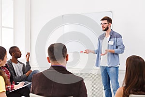 Young man doing presentation in office copy space