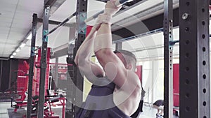 A young man doing pull ups in the Gym