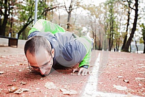 Young Man Doing Push-Ups With One Hand Outdoor Workout