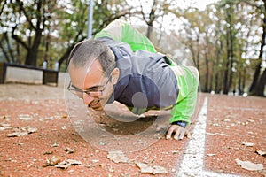 Young Man Doing Push-Ups With One Hand Outdoor Workout