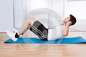 Young man doing sit-ups