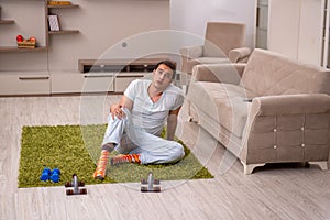 Young man doing sport exercises at home