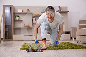 Young man doing sport exercises at home